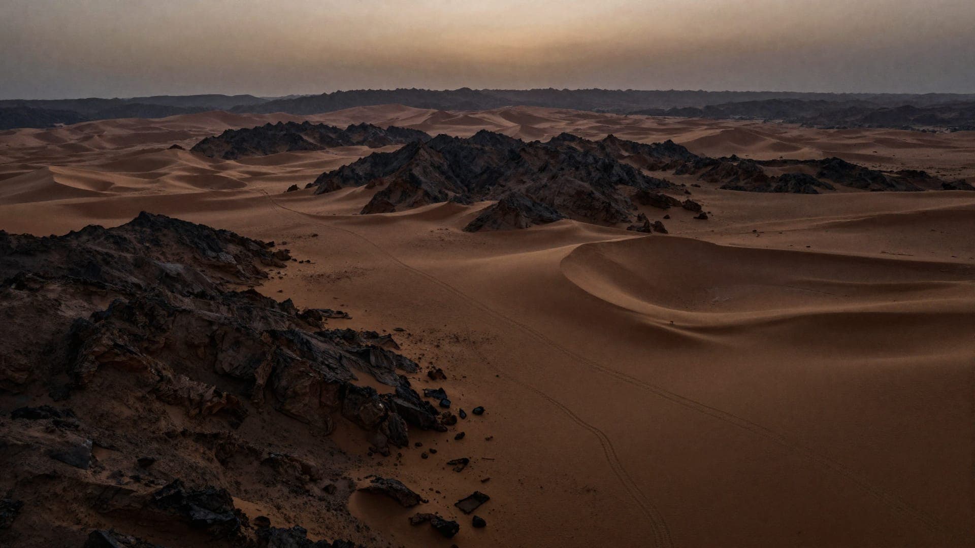 The route of the Grand Traverse — Atlas ridgelines dissolving toward the Sahara at dusk
